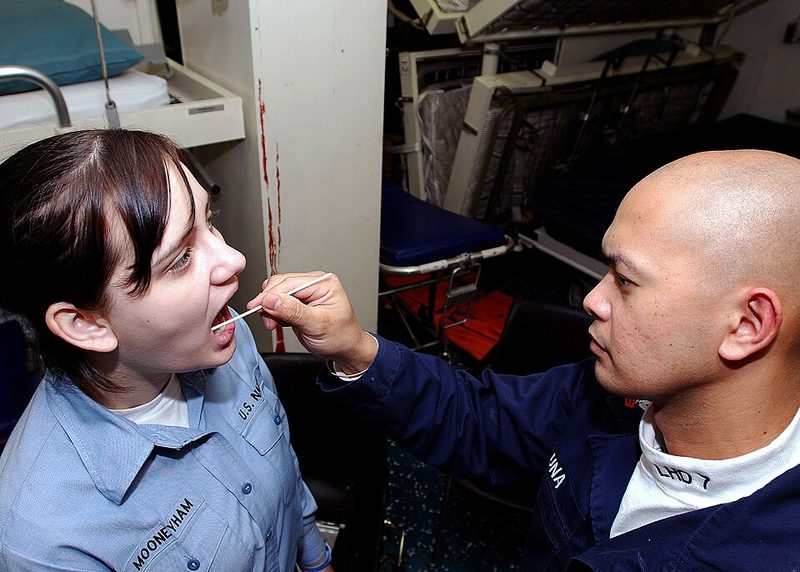 A cheek swab being used to collect a DNA sample